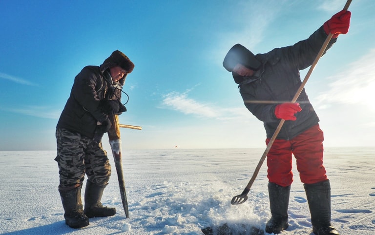 Fishermen Digging A Hole on Iced Chagan Lake
