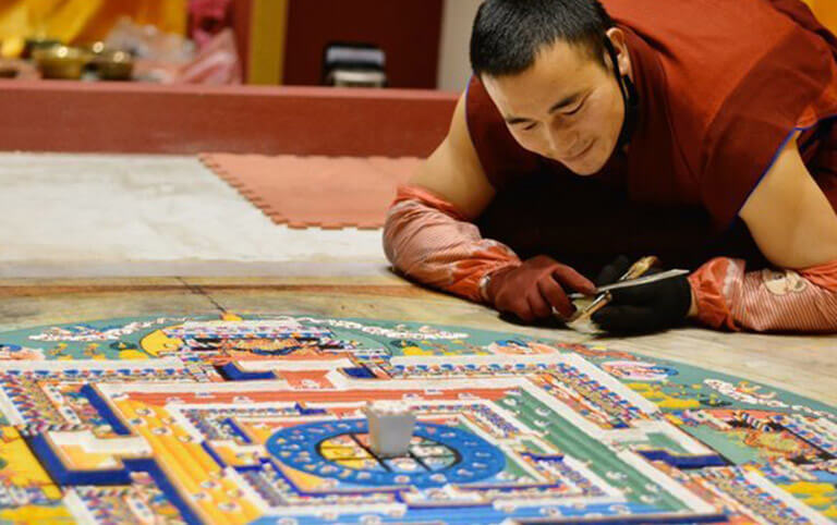 A Tibetan monk was painting Mandala in Wutong Monastery