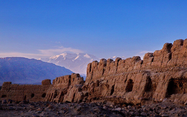 Tashkurgan Fort (Stone City Ruin) with snow mountains as background